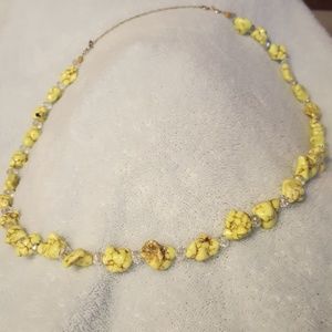 A lite green stone and cut crystal necklace.